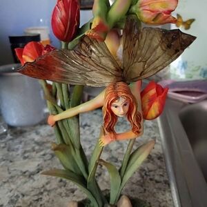 Whimsical Fairy Sculpture with Red Tulips